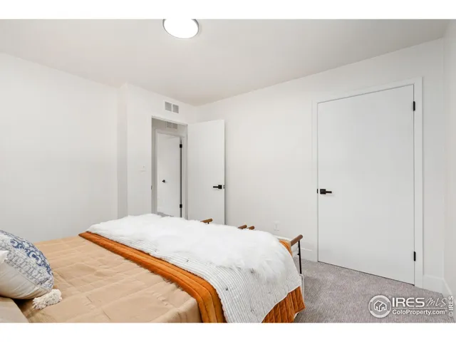 a bedroom with a bed and a table