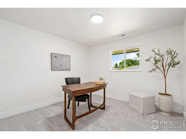 a workspace with furniture and a potted plant