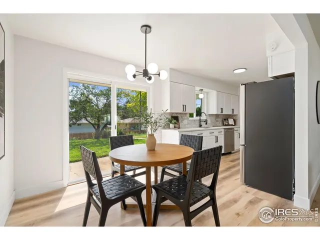 a dining room with furniture a floor to ceiling window and outdoor view