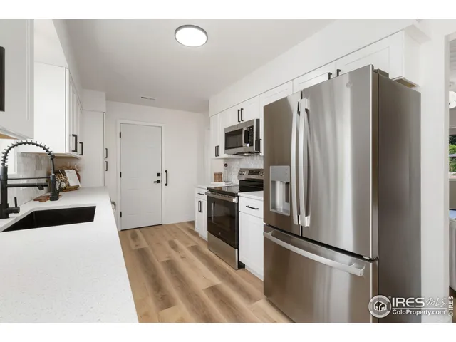 a kitchen with stainless steel appliances a refrigerator and a sink