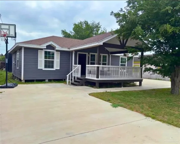 a front view of a house with a garden and porch