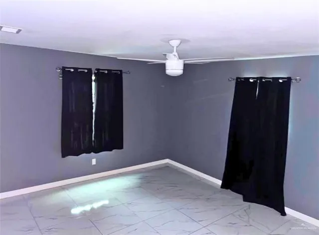 a view of an empty room with a mirror