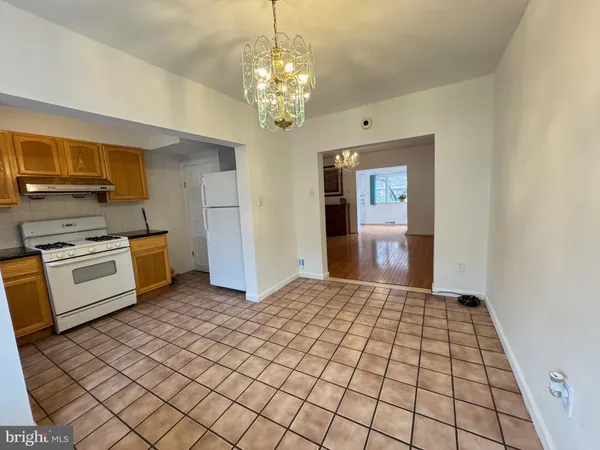 a kitchen with a stove a sink and a refrigerator
