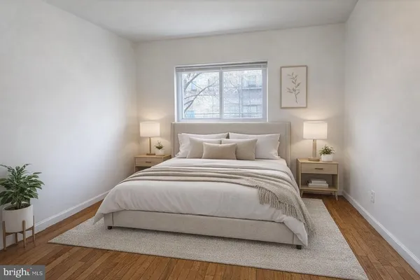 a bedroom with a bed and a potted plant
