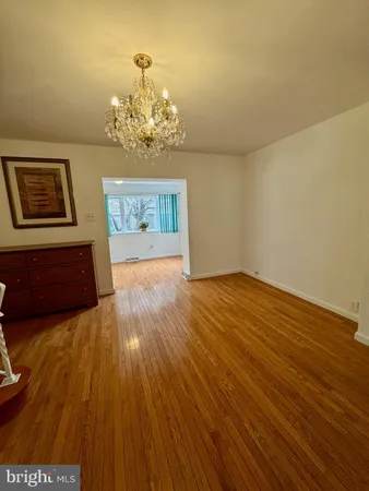 a view of a dining room with furniture and a chandelier