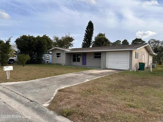 a view of a house with a yard and garage