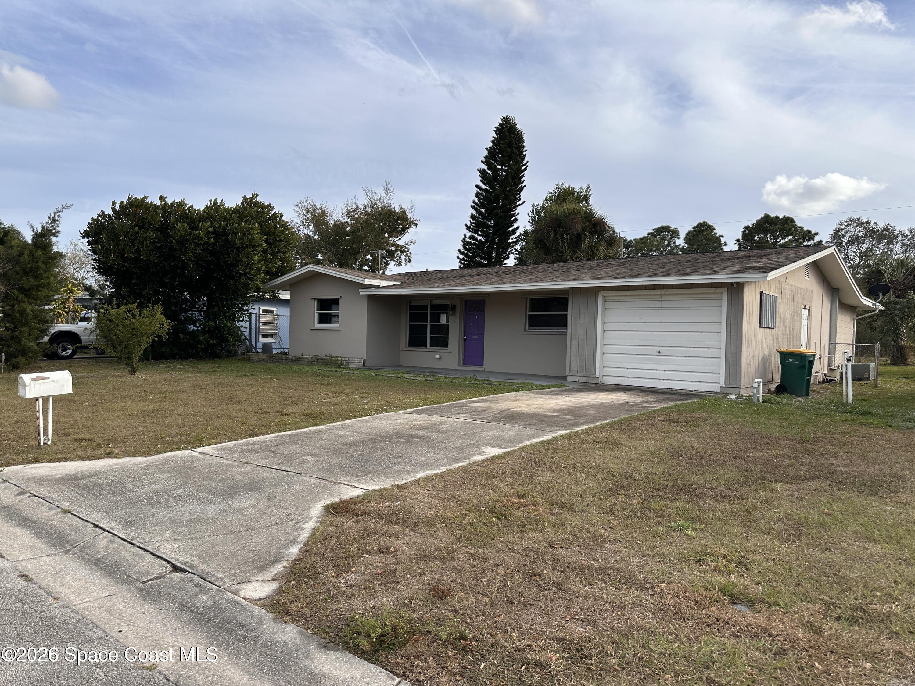 a view of a house with a yard and garage