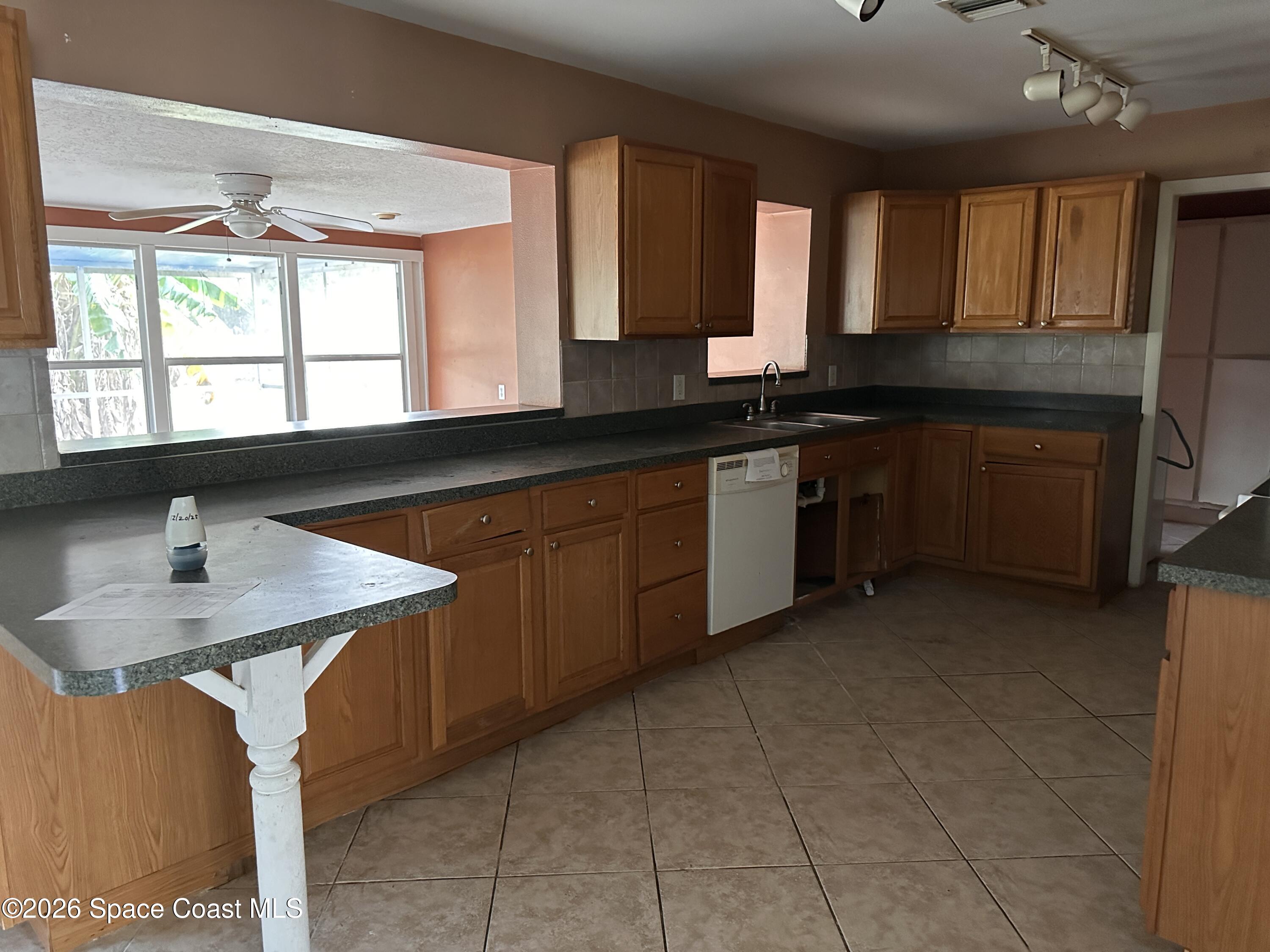 2363 Apache Drive Melbourne, FL 32935 - Photo 12 of 18 a kitchen with a sink and a stove top oven