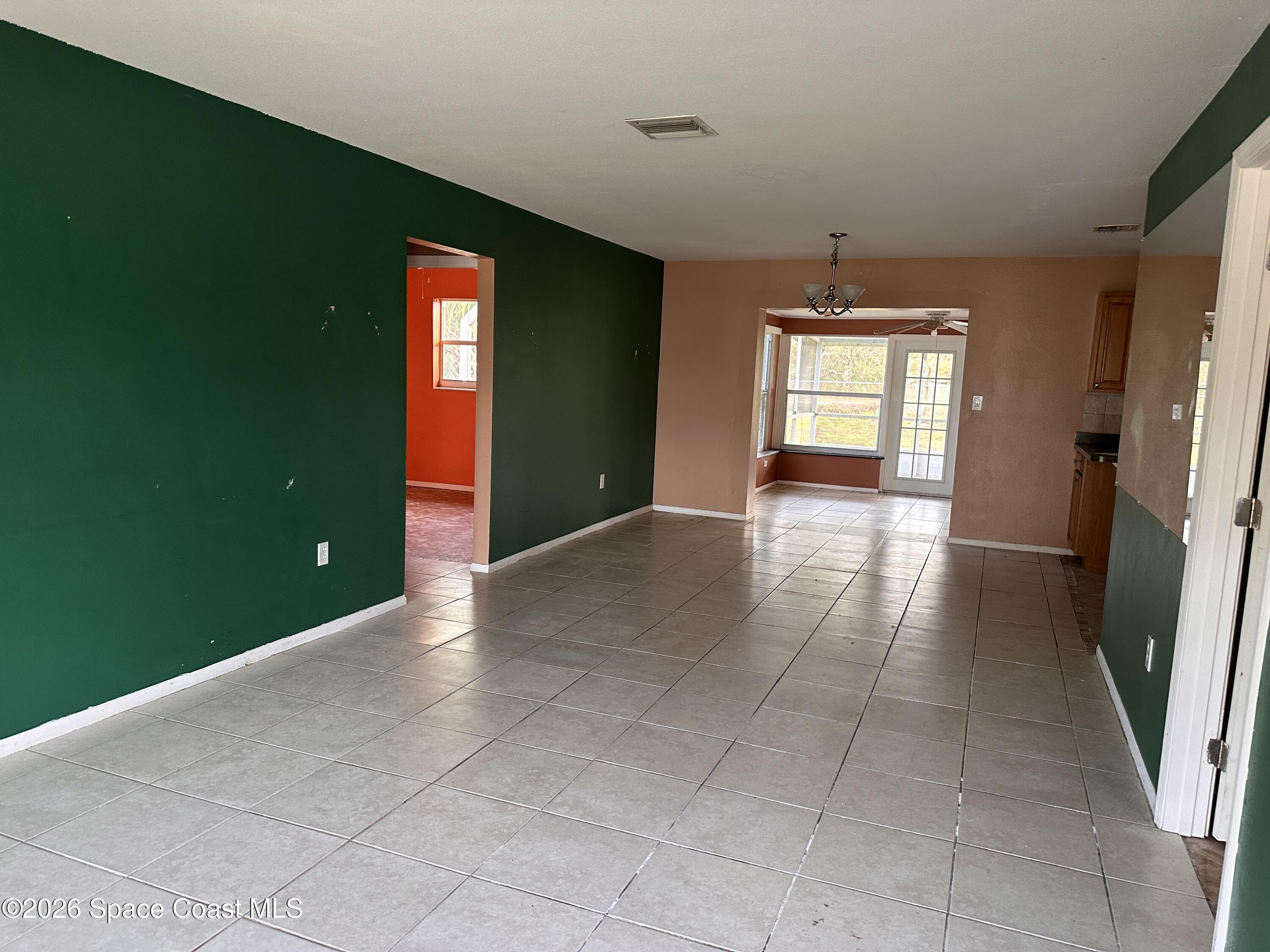 2363 Apache Drive Melbourne, FL 32935 - Photo 7 of 18 wooden floor in an empty room with a window