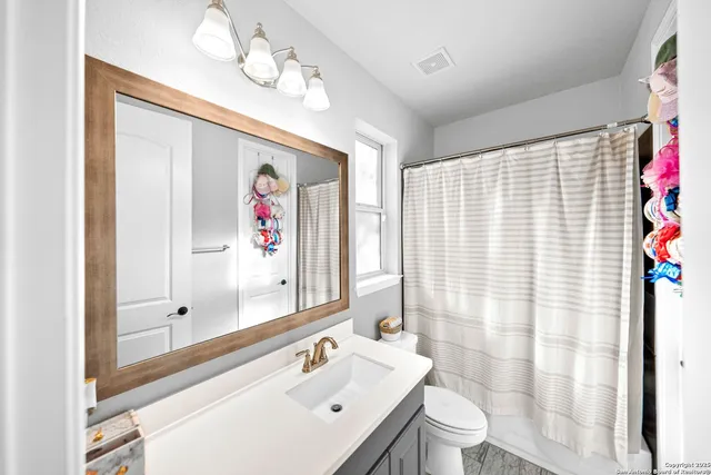 a room with furniture projector and screen