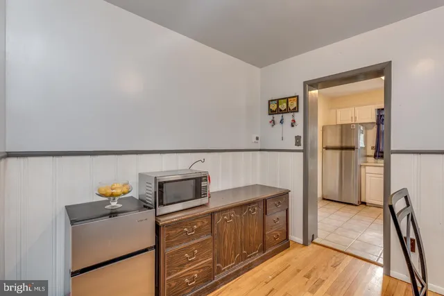 a kitchen with stainless steel appliances a refrigerator and a stove top oven