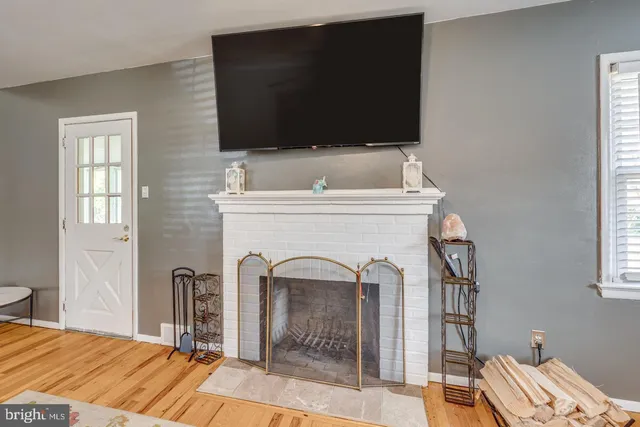 a living room with a fireplace and a flat screen tv