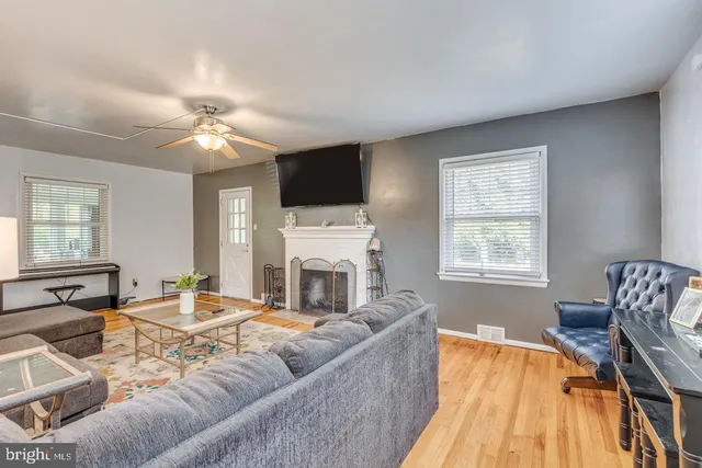 a living room with furniture fireplace and flat screen tv
