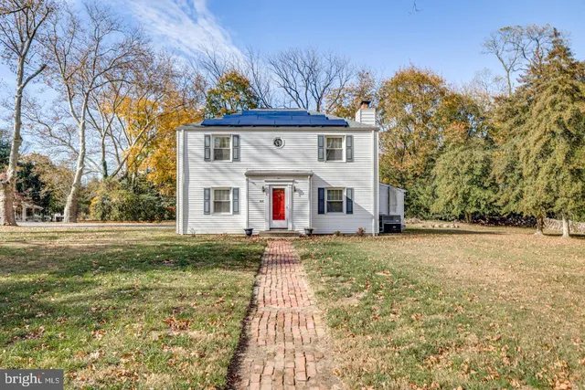a view of a yard with a house in the background