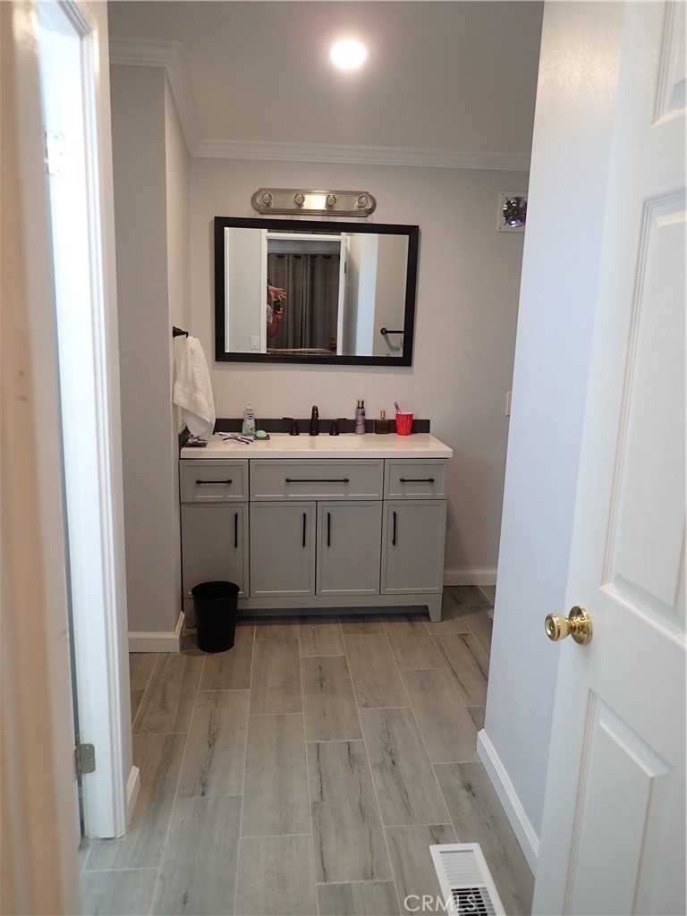 27250 Murrieta Road, Unit 386 Menifee, CA 92586 - Photo 21 of 32 a bathroom with a double vanity sink and mirror