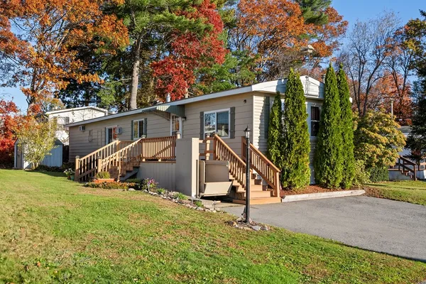 a view of a house with backyard and sitting area