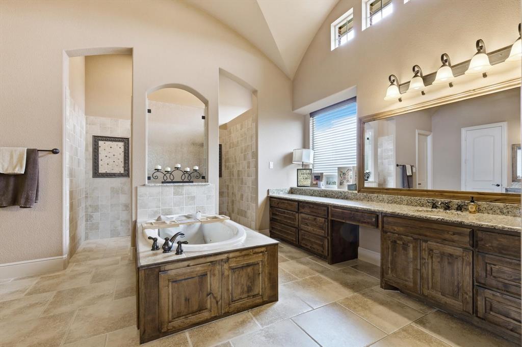 406 Spurgin Road Lucas, TX 75002 - Photo 17 of 39 a large bathroom with a granite countertop double vanity sink a mirror and a bathtub