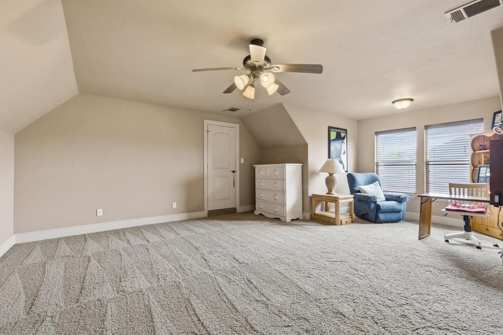 406 Spurgin Road Lucas, TX 75002 - Photo 25 of 39 a view of a livingroom with lounge chair and a ceiling fan