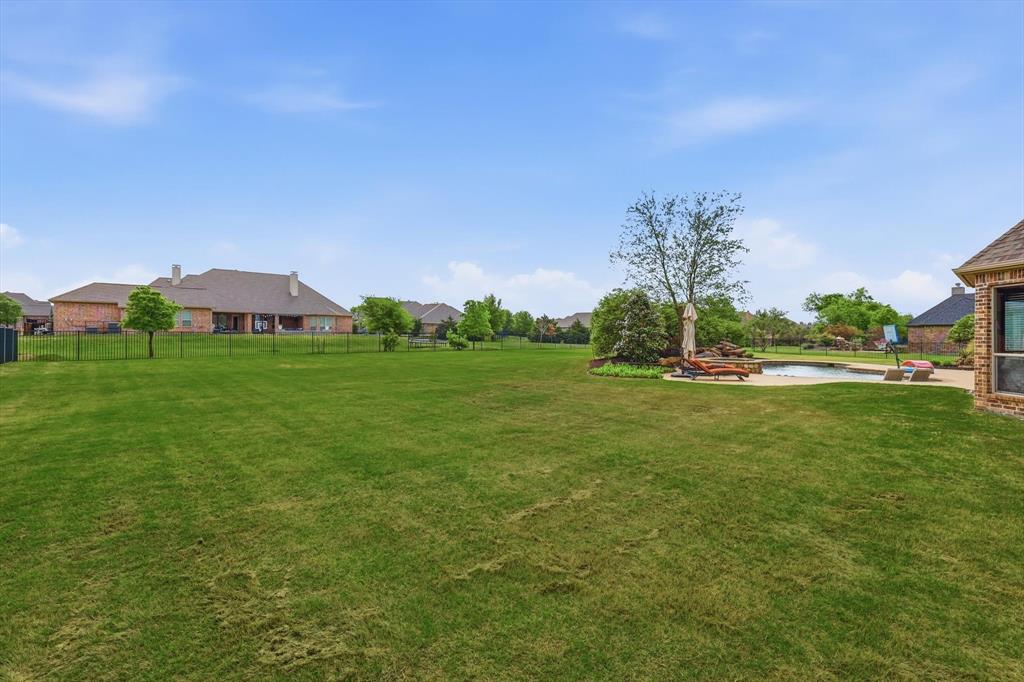 406 Spurgin Road Lucas, TX 75002 - Photo 32 of 39 a backyard of a house with lots of green space