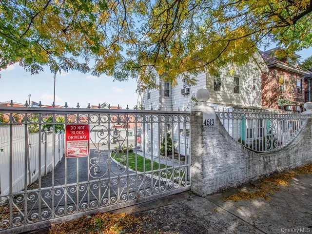 a view of a deck with a large window and wooden fence