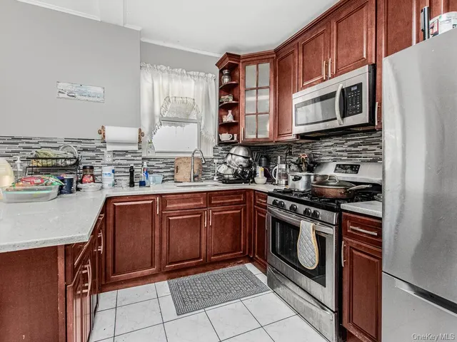 a kitchen with stainless steel appliances granite countertop a stove microwave and sink