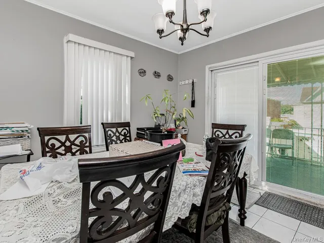 a view of a dining room with furniture and a chandelier