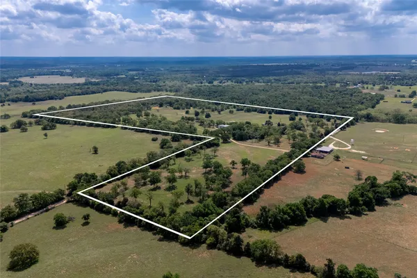 an aerial view of a balcony with lawn chairs