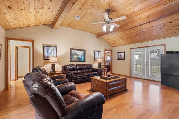 a living room with furniture and a chandelier