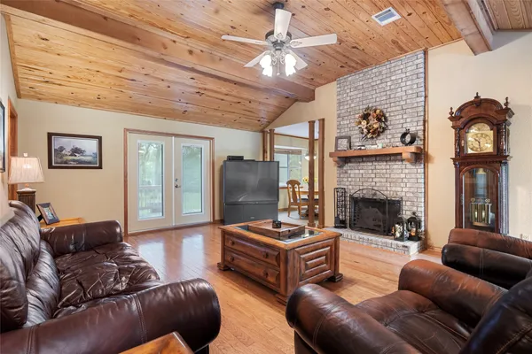 a living room with furniture a fireplace and a chandelier