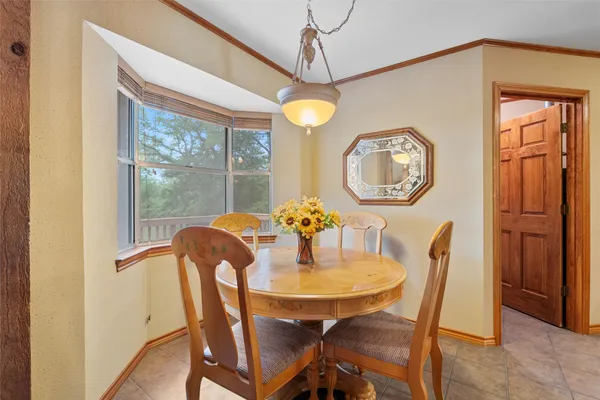 a view of a dining room with furniture chandelier and a window