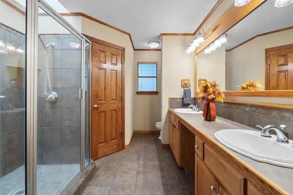 a bathroom with a granite countertop sink mirror and shower