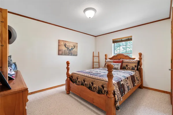 a bed sitting in a bedroom next to a window