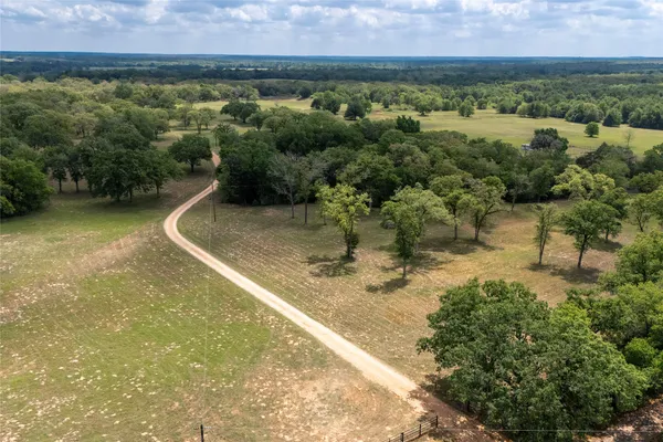 an aerial view of a houses with a yard