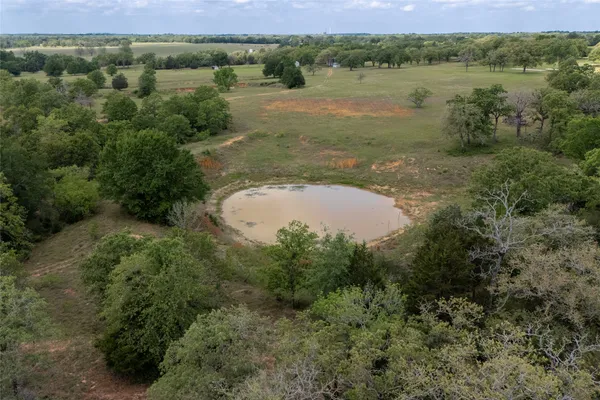 a view of a lake and green valley