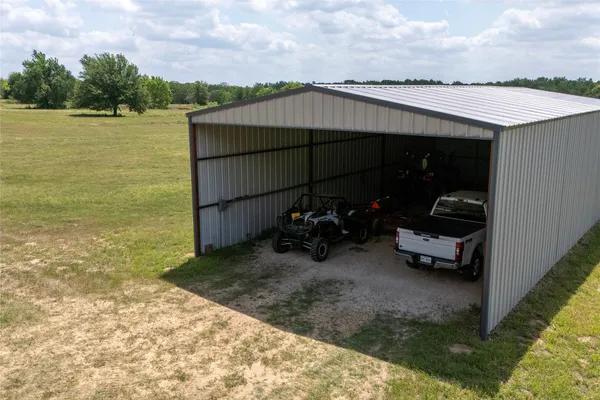 a view of a terrace with a bench and lake view