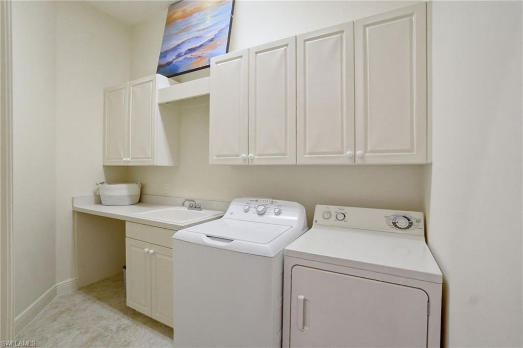17015 Porta Vecchio Way, Unit 101 Naples, FL 34110 - Photo 21 of 39 a utility room with dryer and washer