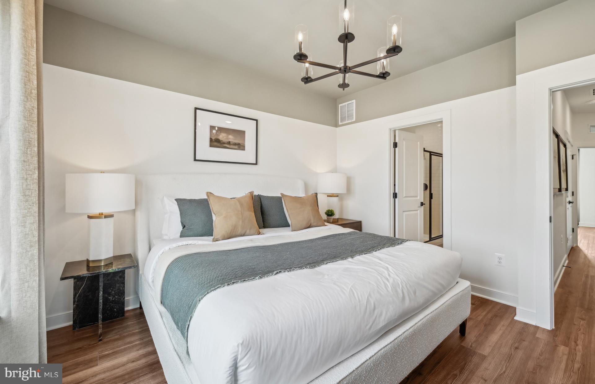 503 Crossvine Lane Laurel, MD 20724 - Photo 16 of 24 a bedroom with bed and a chandelier