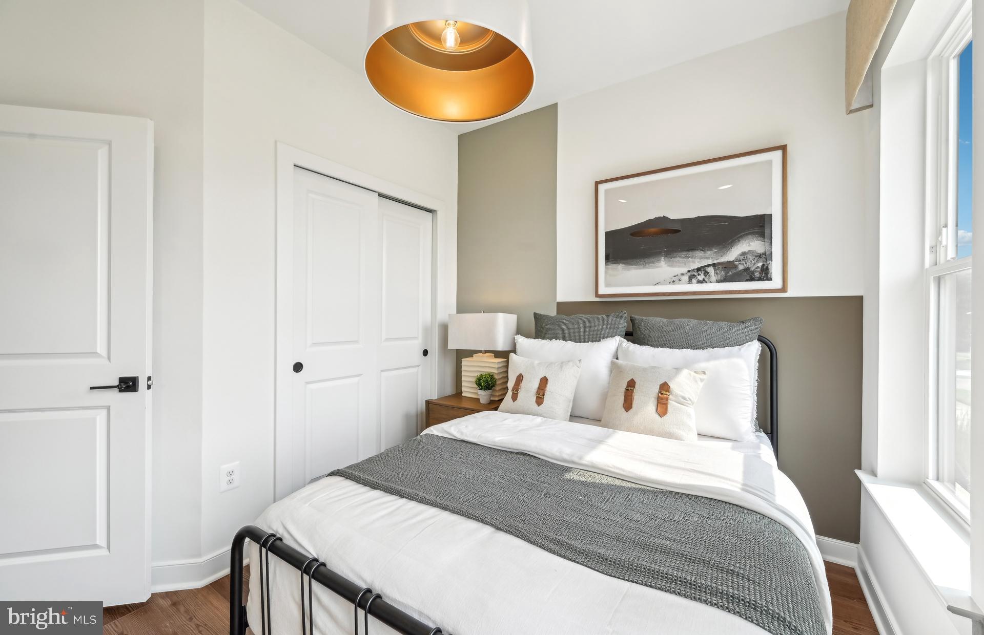 503 Crossvine Lane Laurel, MD 20724 - Photo 3 of 24 a bedroom with a bed and a painting on the wall