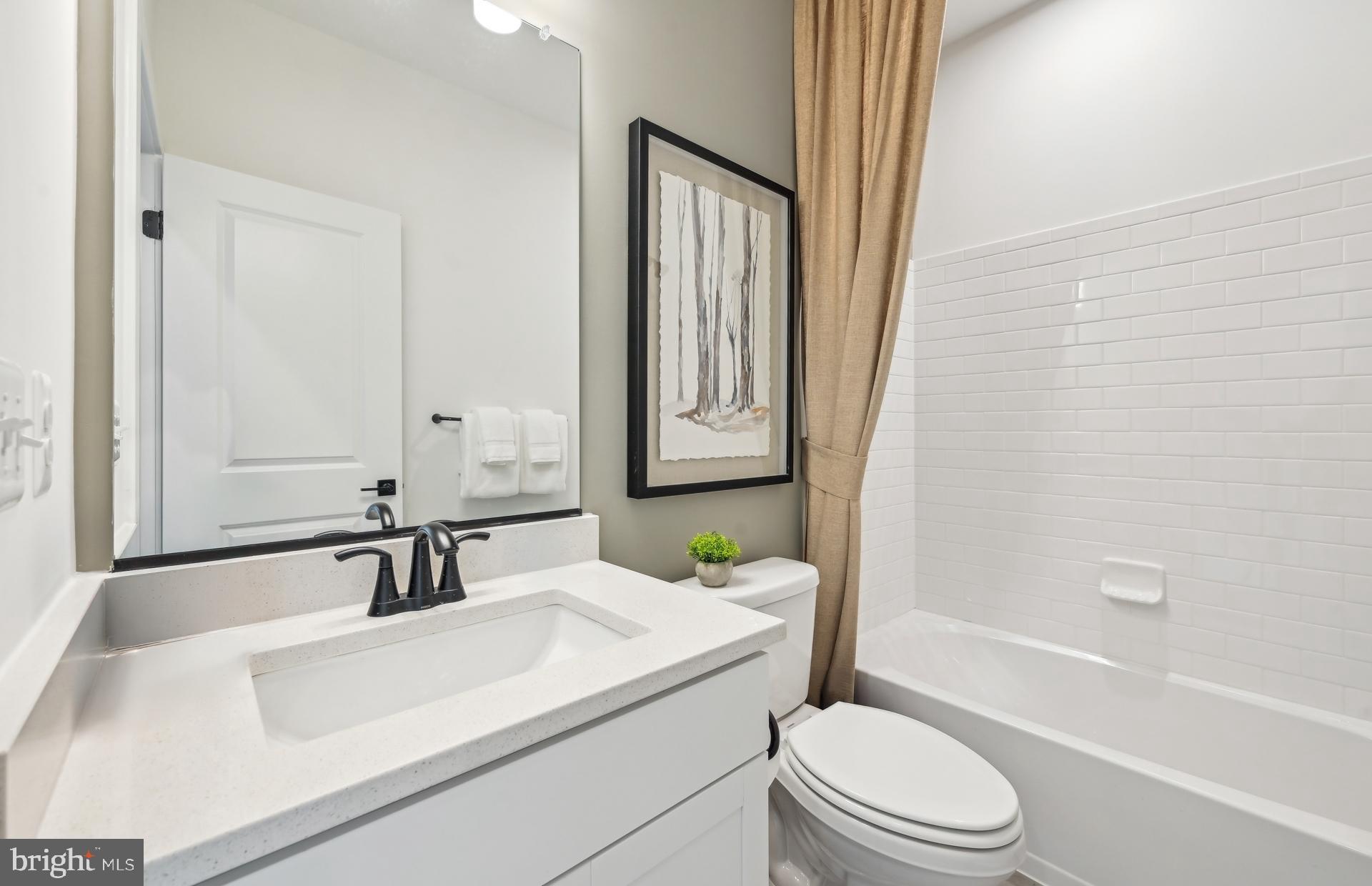 503 Crossvine Lane Laurel, MD 20724 - Photo 4 of 24 a bathroom with a sink a toilet and shower