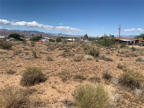 a view of a building with mountains in the background