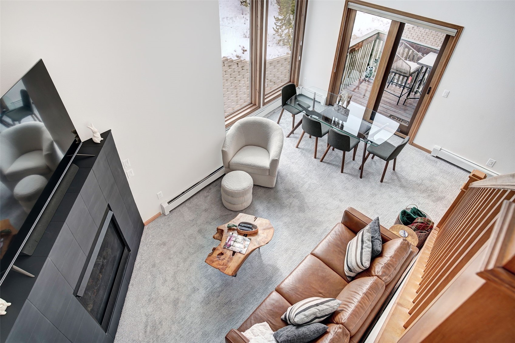 3710 Ryan Gulch Road, Unit 378 Silverthorne, CO 80498 - Photo 13 of 31 Carpeted living room featuring a baseboard heating unit and a fireplace