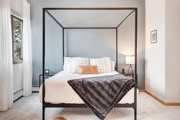 a bedroom with a bed and window