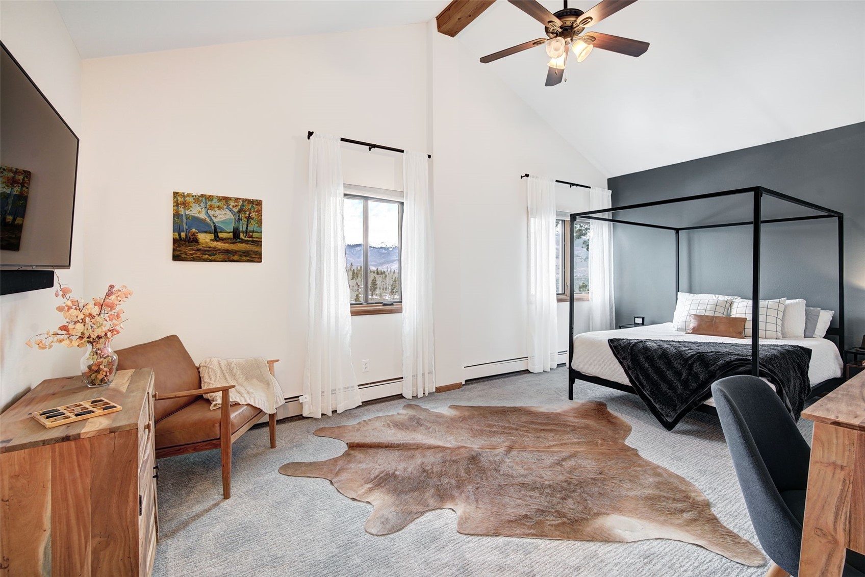 3710 Ryan Gulch Road, Unit 378 Silverthorne, CO 80498 - Photo 18 of 31 Carpeted bedroom with a ceiling fan and a baseboard heating unit