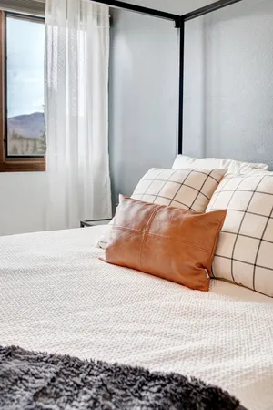 a bedroom with a bed and a window