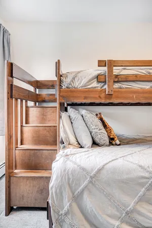 a bedroom with a bed and balcony view