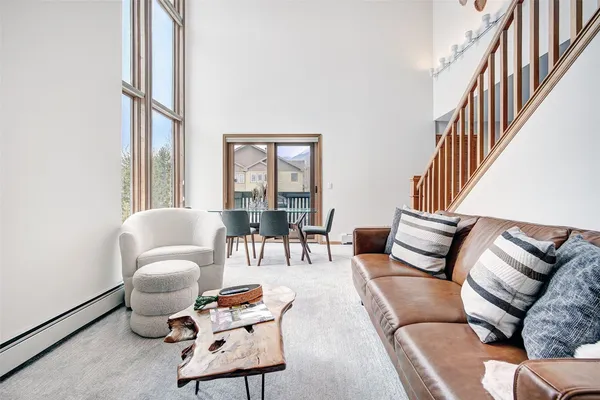 a living room with furniture fireplace and a window