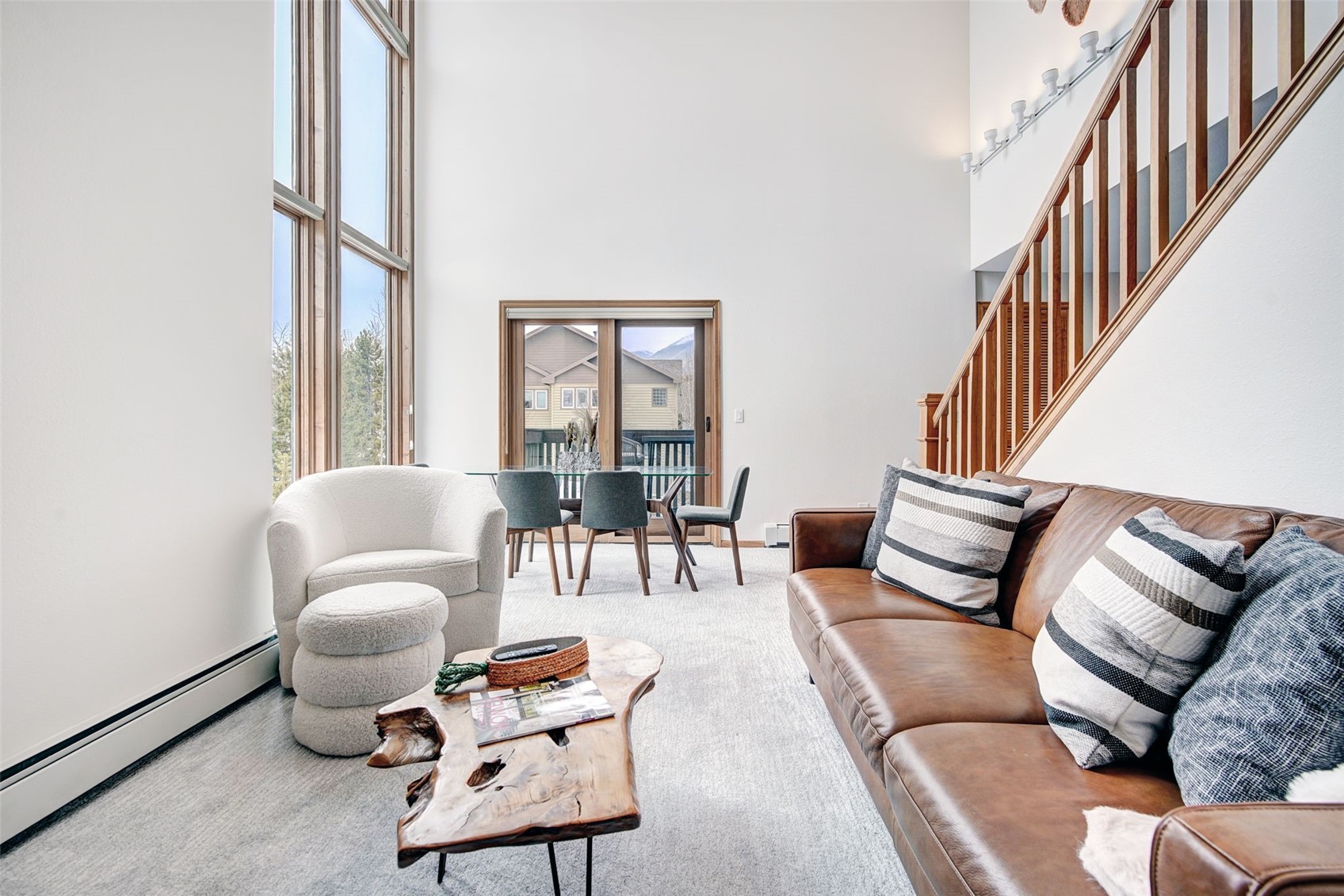 3710 Ryan Gulch Road, Unit 378 Silverthorne, CO 80498 - Photo 3 of 31 Carpeted living room with baseboard heating and a high ceiling