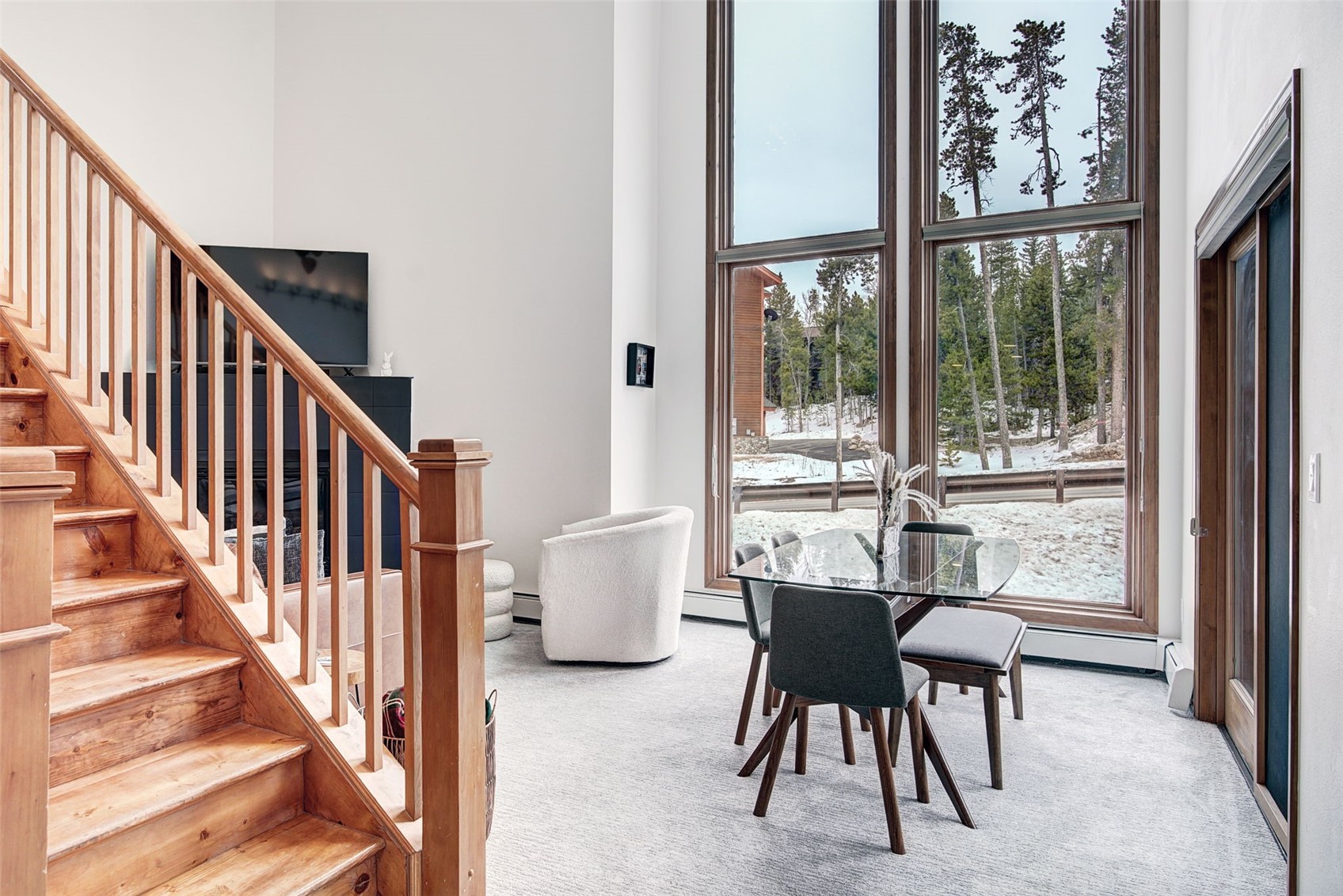 3710 Ryan Gulch Road, Unit 378 Silverthorne, CO 80498 - Photo 6 of 31 Dining room with light carpet and a high ceiling