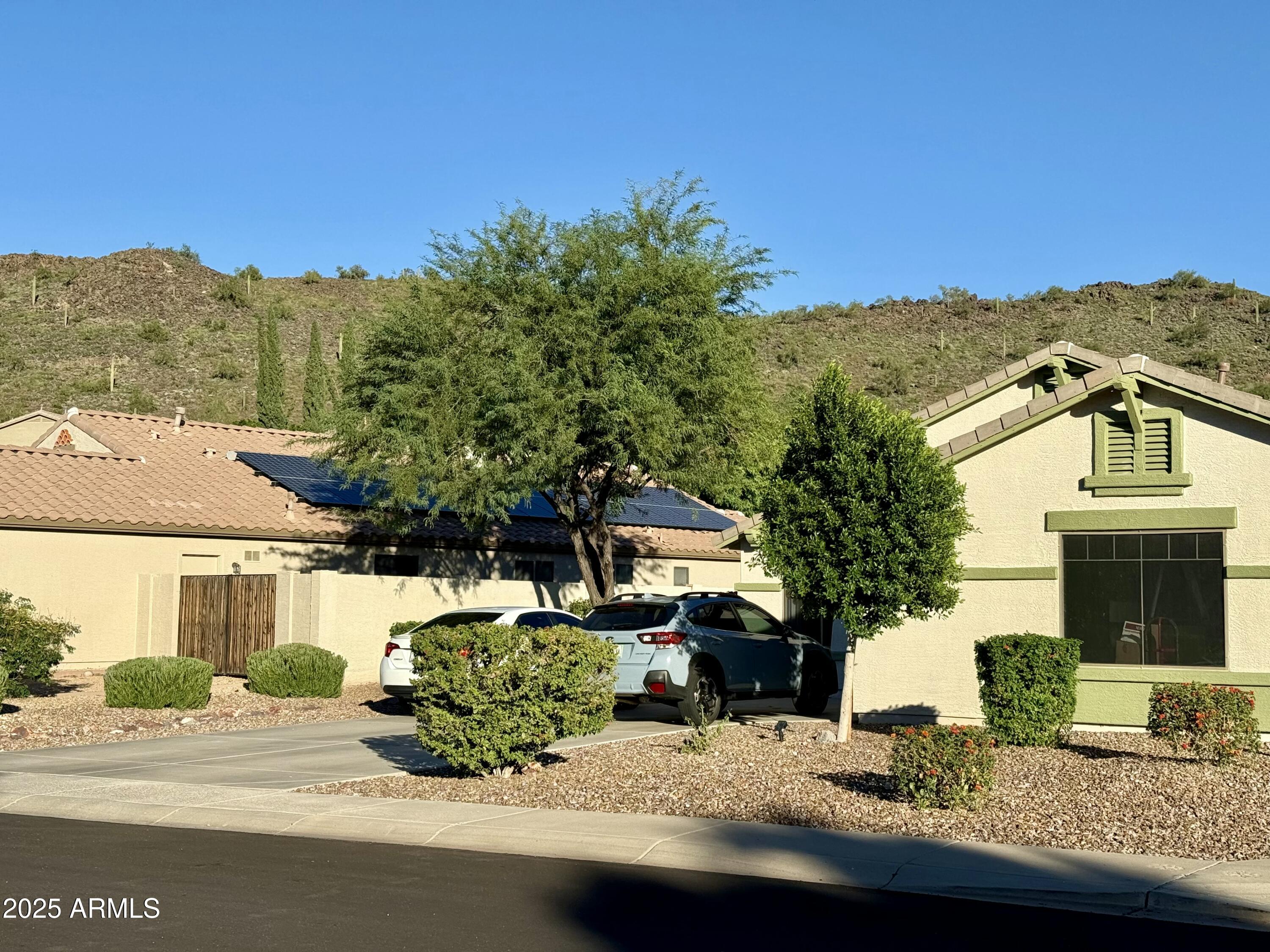4038 West Alex Loop Phoenix, AZ 85083 - Photo 18 of 36 a front view of a house with a yard