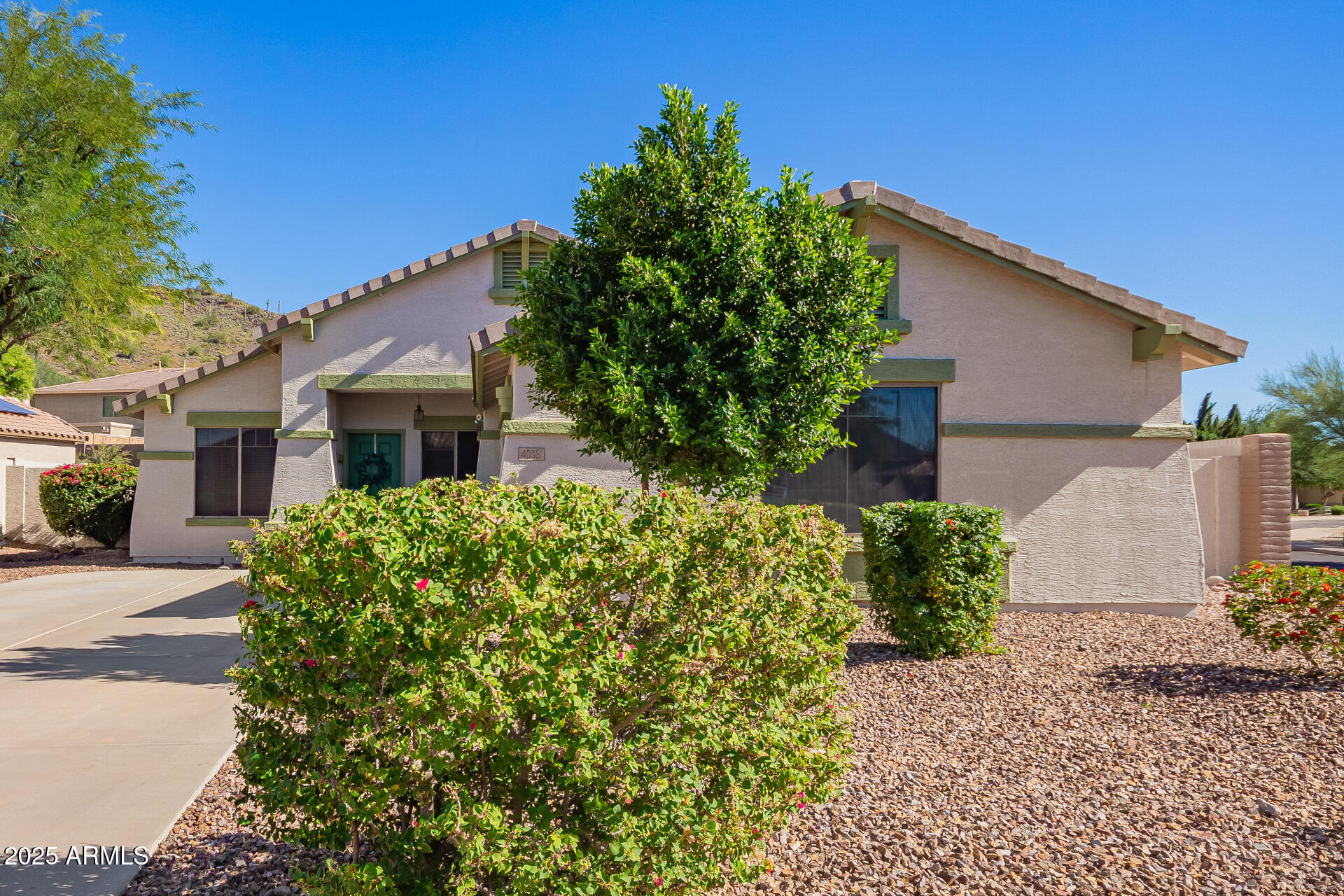 4038 West Alex Loop Phoenix, AZ 85083 - Photo 18 of 37 a front view of a house with garden
